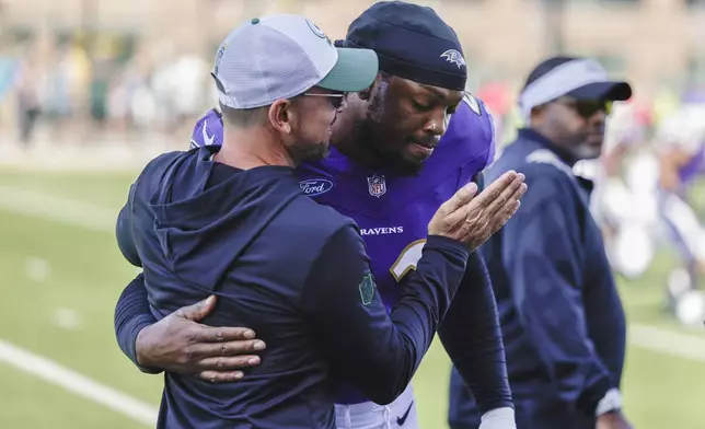 Green Bay Packers head coach Matt LaFleur and Baltimore Ravens running back Derrick Henry (22) greet each other on the field during an NFL football joint training camp practice Thursday, Aug. 22, 2024, in Green Bay, Wis. (AP Photo/Matt Ludtke)