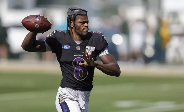 Baltimore Ravens quarterback Lamar Jackson throws a pass during an NFL football joint training camp practice with the Green Bay Packers Thursday, Aug. 22, 2024, in Green Bay, Wis. (AP Photo/Matt Ludtke)