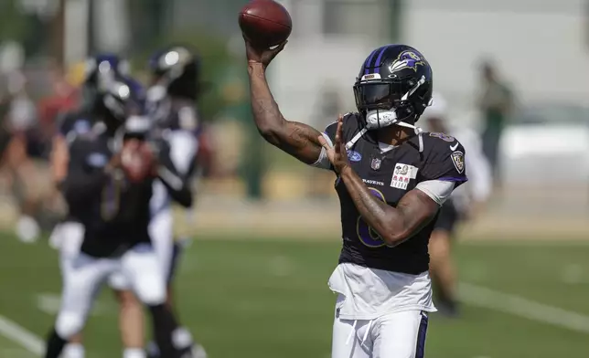 Baltimore Ravens quarterback Lamar Jackson throws a pass during an NFL football joint training camp practice with the Green Bay Packers Thursday, Aug. 22, 2024, in Green Bay, Wis. (AP Photo/Matt Ludtke)