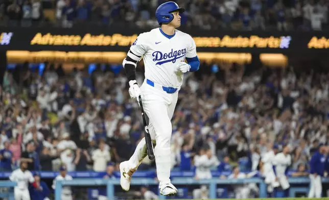 Los Angeles Dodgers designated hitter Shohei Ohtani (17) hits a grand slam during the ninth inning of a baseball game against the Tampa Bay Rays in Los Angeles, Friday, Aug. 23, 2024. The Dodgers won 7-3. Will Smith, Tommy Edman, and Max Muncy also scored. (AP Photo/Ashley Landis)