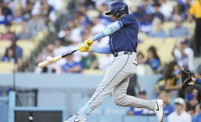 Tampa Bay Rays' Christopher Morel doubles during the first inning of a baseball game against the Los Angeles Dodgers in Los Angeles, Saturday, Aug. 24, 2024. Junior Caminero scored. (AP Photo/Ashley Landis)