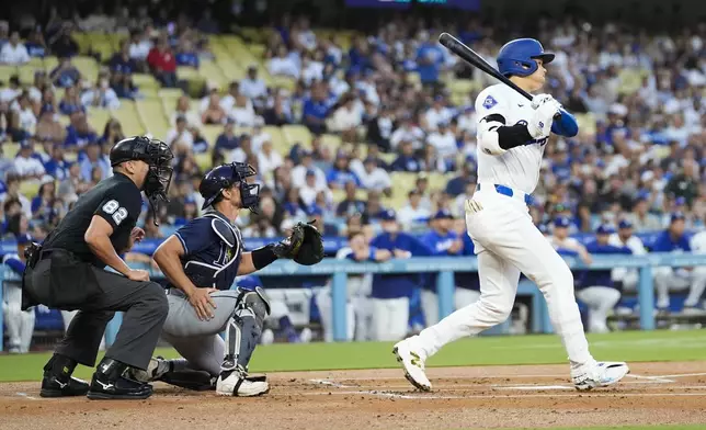 Los Angeles Dodgers designated hitter Shohei Ohtani (17) lines out during the first inning of a baseball game against the Tampa Bay Rays in Los Angeles, Friday, Aug. 23, 2024. (AP Photo/Ashley Landis)