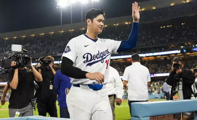 Los Angeles Dodgers designated hitter Shohei Ohtani (17) leaves the field after hitting a grand slam during the ninth inning of a baseball game against the Tampa Bay Rays in Los Angeles, Friday, Aug. 23, 2024. The Dodgers won 7-3. Will Smith, Tommy Edman, and Max Muncy also scored. (AP Photo/Ashley Landis)