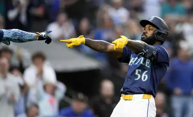 Seattle Mariners' Randy Arozarena celebrates with Julio Rodríguez, left, after hitting a three-run home run against the Tampa Bay Rays during the third inning of a baseball game, Monday, Aug. 26, 2024, in Seattle. (AP Photo/Lindsey Wasson)