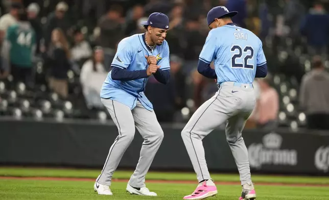 Tampa Bay Rays designated hitter Christopher Morel celebrates with center fielder Jose Siri (22) after 3-2 win against the Seattle Mariners in a baseball game, Tuesday, Aug. 27, 2024, in Seattle. (AP Photo/Lindsey Wasson)