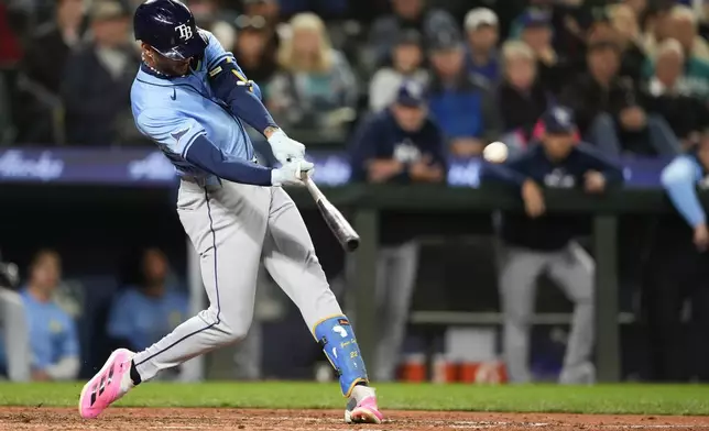 Tampa Bay Rays' Jose Siri hits a two-run home run against the Seattle Mariners during the seventh inning of a baseball game, Tuesday, Aug. 27, 2024, in Seattle. (AP Photo/Lindsey Wasson)