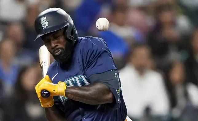 Seattle Mariners' Randy Arozarena is hit by a pitch from Tampa Bay Rays starter Ryan Pepiot during the fifth inning of a baseball game Monday, Aug. 26, 2024, in Seattle. (AP Photo/Lindsey Wasson)