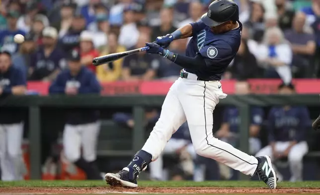 Seattle Mariners' Jorge Polanco hits a solo home run against the Tampa Bay Rays during the second inning of a baseball game Monday, Aug. 26, 2024, in Seattle. (AP Photo/Lindsey Wasson)