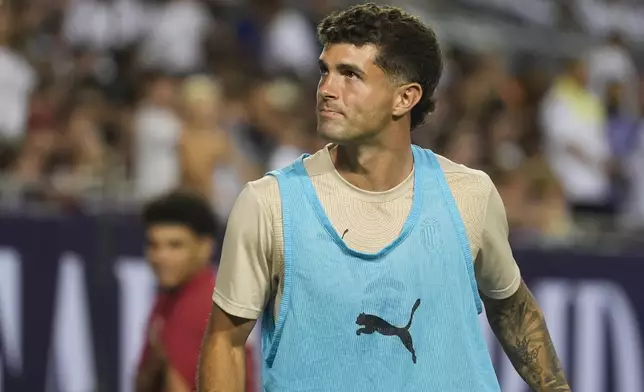 AC Milan forward Christian Pulisic warms up on the sidelines during the second half of a friendly soccer match against Real Madrid, Wednesday, July 31, 2024, in Chicago. (AP Photo/Erin Hooley)