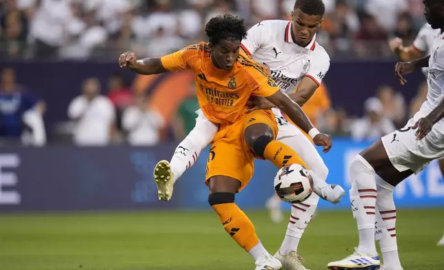 Real Madrid forward Endryck Moreira, left, and Milan defender Malick Thiaw fight for control of the ball during the first half of a friendly soccer match Wednesday, July 31, 2024, in Chicago. (AP Photo/Erin Hooley)