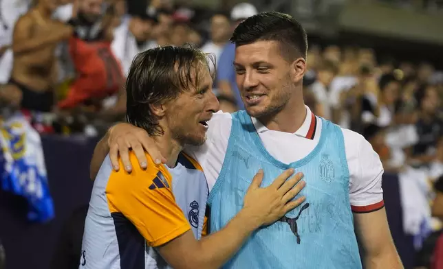 Real Madrid midfielder Luka Modrić, left, and Milan forward Luka Jović greet each other on the sidelines during the second half of a friendly soccer match Wednesday, July 31, 2024, in Chicago. (AP Photo/Erin Hooley)