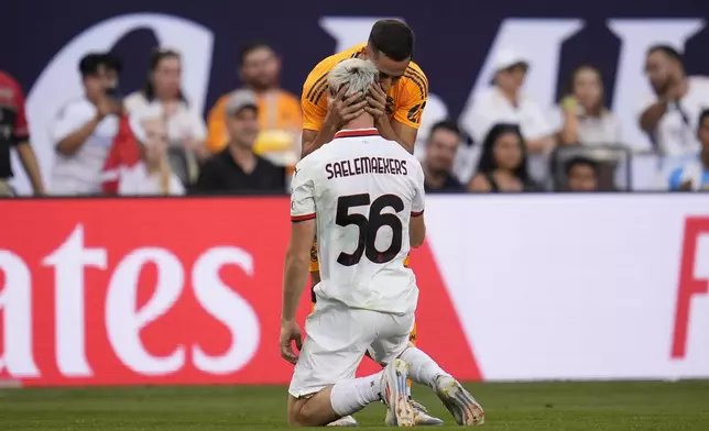 Real Madrid midfielder Lucas Vázquez grabs the head of AC Milan midfielder Alexis Saelemaekers after running into him during the first half of a friendly soccer match Wednesday, July 31, 2024, in Chicago. (AP Photo/Erin Hooley)