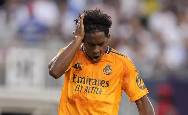 Real Madrid forward Endryck Moreira smacks his head after missing a shot during the first half of a friendly soccer match against AC Milan, Wednesday, July 31, 2024, in Chicago. (AP Photo/Erin Hooley)