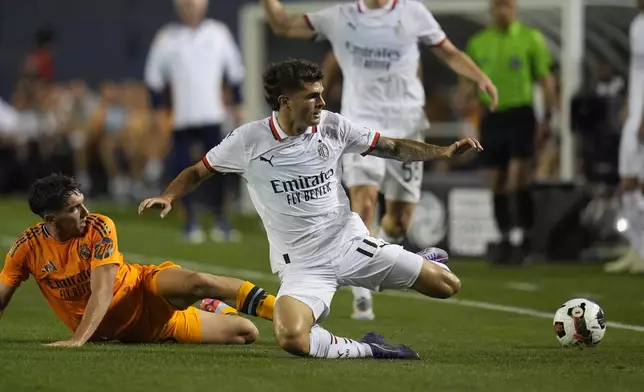 Real Madrid midfielder Mario Martín, left, and Milan forward Christian Pulisic chase the ball during the second half of a friendly soccer match Wednesday, July 31, 2024, in Chicago. (AP Photo/Erin Hooley)