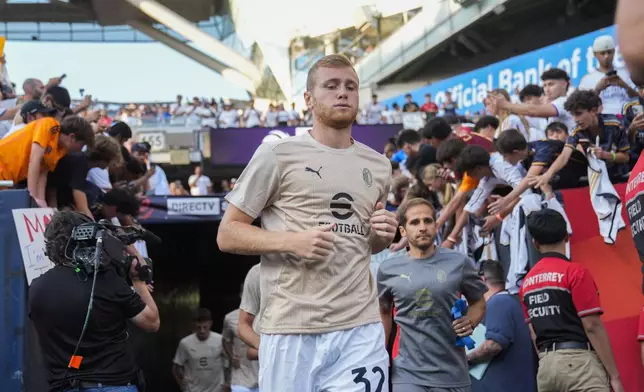 Milan midfielder Tommaso Pobega takes the field with his team before a friendly soccer match against Real Madrid, Wednesday, July 31, 2024, in Chicago. (AP Photo/Erin Hooley)