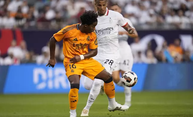 Real Madrid forward Endryck Moreira, left, and Milan defender Malick Thiaw fight for control of the ball during the first half of a friendly soccer match Wednesday, July 31, 2024, in Chicago. (AP Photo/Erin Hooley)