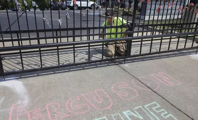 The bottom of a fence surrounding the Ferguson, Mo., police station is repaired on Saturday, Aug. 10, 2024 after it was damaged during a protest outside the police station on Friday night. (David Carson/St. Louis Post-Dispatch via AP)