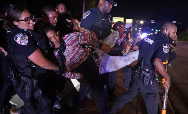 Ferguson police arrest Elijah Gant outside the Ferguson, Mo., police department on Friday, Aug. 9, 2024, after protests turned to turmoil on the 10th anniversary of Michael Brown's death at a gathering of several of the original protesters. (Christian Gooden//St. Louis Post-Dispatch via AP)