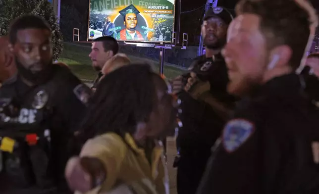 Protesters lash out verbally at Ferguson, Mo., police on Friday, Aug. 9, 2024, after protests turned to turmoil with a couple of arrests outside the police department on the 10th anniversary of Michael Brown's death at a gathering of several of the original protesters. (Christian Gooden//St. Louis Post-Dispatch via AP)