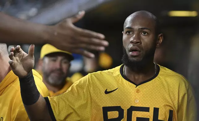 Pittsburgh Pirates outfielder Bryan De La Cruz celebrates after scoring against the Cincinnati Reds in the fifth inning of a baseball game, Friday, Aug. 23, 2024, in Pittsburgh. (AP Photo/Barry Reeger)