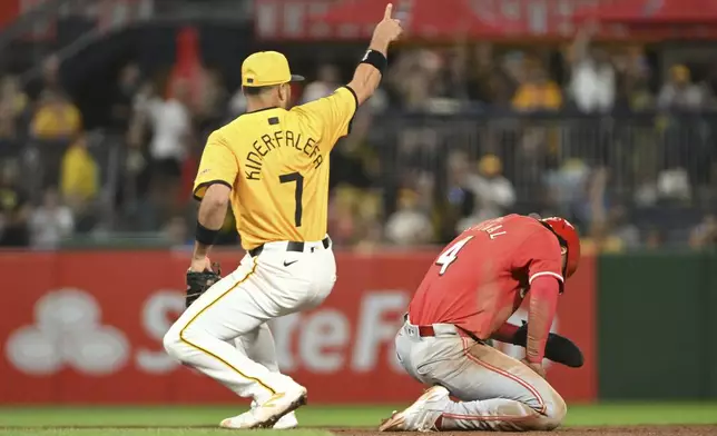 Pittsburgh Pirates third base Isiah Kiner-Falefa (7) celebrates after tagging out Cincinnati Reds' Santiago Espinal (4) in the seventh inning of a baseball game, Friday, Aug. 23, 2024, in Pittsburgh. (AP Photo/Barry Reeger)