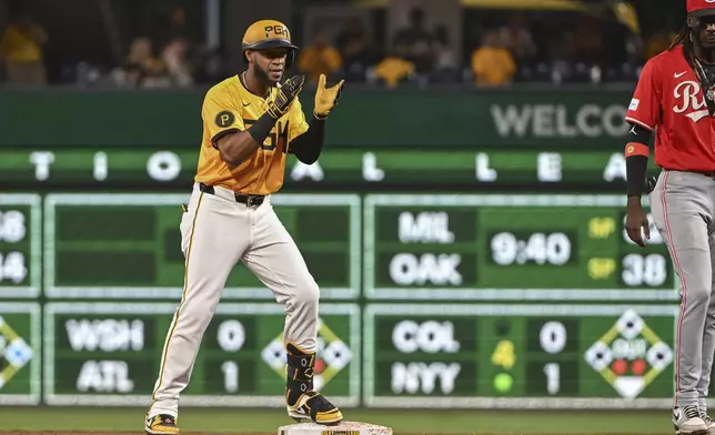 Pittsburgh Pirates outfielder Bryan De La Cruz celebrates after driving in a run against the Cincinnati Reds in the fifth inning of a baseball game, Friday, Aug. 23, 2024, in Pittsburgh. (AP Photo/Barry Reeger)