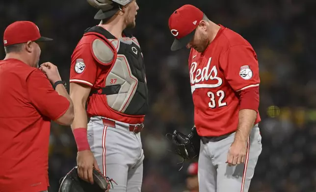 Cincinnati Reds pitcher Justin Wilson (32) reacts during the sixth inning of a baseball game against the Pittsburgh Pirates, Friday, Aug. 23, 2024, in Pittsburgh. (AP Photo/Barry Reeger)