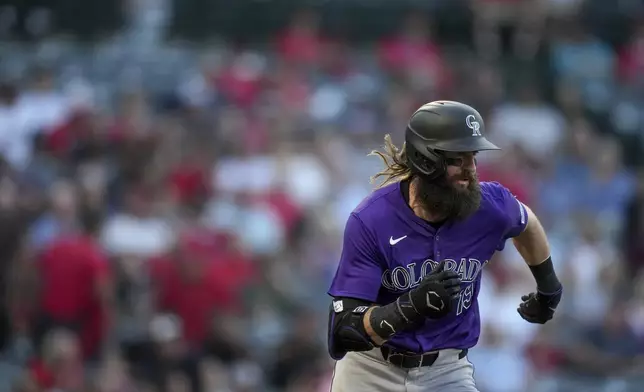 Colorado Rockies designated hitter Charlie Blackmon runs to first base during the third inning of a baseball game against the Los Angeles Angels in Anaheim, Calif., Thursday, Aug. 1, 2024. (AP Photo/Eric Thayer)