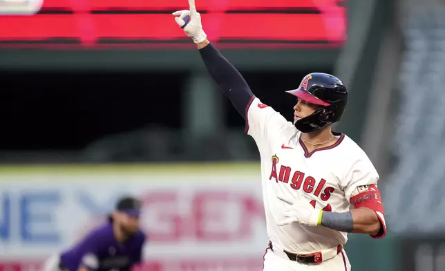 Los Angeles Angels' Logan O'Hoppe celebrates while running the bases after hitting a home run during the fourth inning of a baseball game against the Colorado Rockies in Anaheim, Calif., Thursday, Aug. 1, 2024. (AP Photo/Eric Thayer)