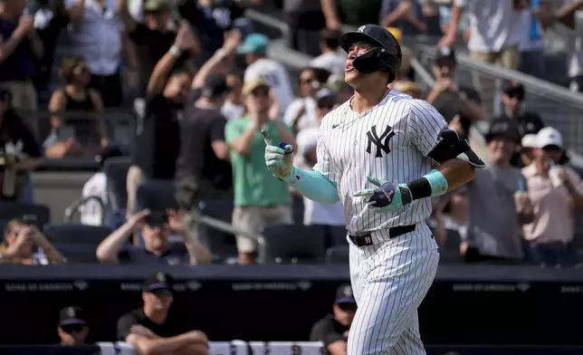 New York Yankees' Aaron Judge crosses home plate after hitting a home run during the seventh inning of a baseball game against the Colorado Rockies, Sunday, Aug. 25, 2024, in New York. (AP Photo/Bryan Woolston)