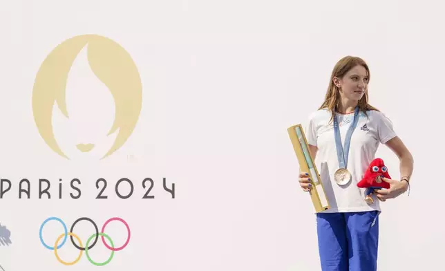 Romanian gymnast Ana Barbosu poses with the bronze medal for her women's artistic gymnastics individual floor performance at the Paris 2024 Olympics, after receiving it during a ceremony at the Romanian Olympic and Sports Committee, in Bucharest, Romania, Friday, Aug. 16, 2024. American gymnast Jordan Chiles called an arbitration panel's decision that dropped her out of the bronze medal position in the floor exercise at the Paris Olympics "unjust" and a "significant blow" in a message posted on social media Thursday. (AP Photo/Vadim Ghirda)