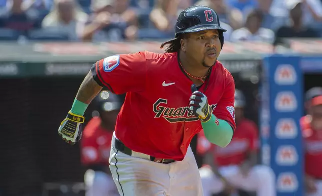 Cleveland Guardians' Jose Ramirez runs to first base after hitting a double off Kansas City Royals relief pitcher Kris Bubic during the seventh inning of the first game of a baseball doubleheader in Cleveland, Monday, Aug. 26, 2024. (AP Photo/Phil Long)