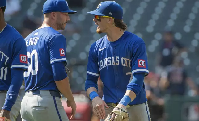 Kansas City Royals' Bobby Witt Jr., right, congratulates Lucas Erceg, left, at the end of the first game of a baseball doubleheader against the Cleveland Guardians in Cleveland, Monday, Aug. 26, 2024. (AP Photo/Phil Long)