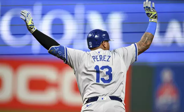 Kansas City Royals' Salvador Perez celebrates hitting a grand slam during the sixth inning of the second game of a baseball doubleheader against the Cleveland Guardians, Monday, Aug. 26, 2024, in Cleveland. (AP Photo/Nick Cammett)