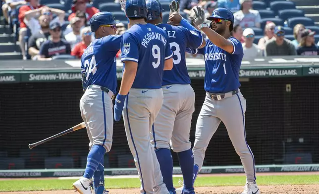 Kansas City Royals' MJ Melendez (1) is greeted by Freddy Fermin, left, Vinnie Pasquantino (9) and Salvador Perez, center right, after his three-run home run off Cleveland Guardians relief pitcher Eli Morgan during the fourth inning of the first game of a baseball doubleheader in Cleveland, Monday, Aug. 26, 2024. (AP Photo/Phil Long)