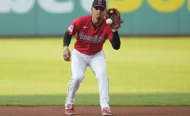 Cleveland Guardians second baseman Andres Gimenez fields a ground ball hit for an out by Kansas City Royals' Vinnie Pasquantino in the first inning of a baseball game, Tuesday, Aug. 27, 2024, in Cleveland. (AP Photo/Sue Ogrocki)