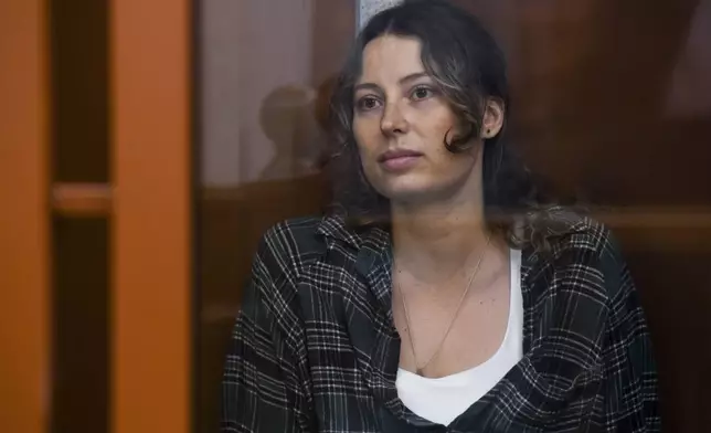 FILE - Ksenia Karelina, also known by the last name of Khavana, sits in a defendant's cage in a court in Yekaterinburg, Russia, on Thursday, June 20, 2024. (AP Photo, File)