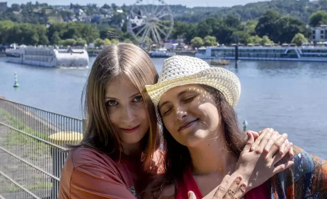 Freed Russian artist Sasha Skochilenko, left, and her partner, Sofya Subbotina, stand near the Mosel River in Koblenz, Germany, Saturday, Aug. 10, 2024. (AP Photo/Michael Probst)