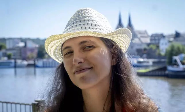 Freed Russian artist Sasha Skochilenko stands on the banks of the Mosel River in Koblenz, Germany, Saturday, Aug. 10, 2024. (AP Photo/Michael Probst)