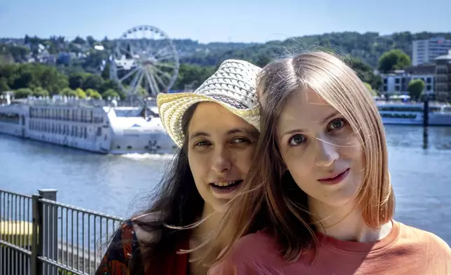 Freed Russian artist Sasha Skochilenko, left, and her partner, Sofya Subbotina, stand near the Mosel River in Koblenz, Germany, Saturday, Aug. 10, 2024. (AP Photo/Michael Probst)