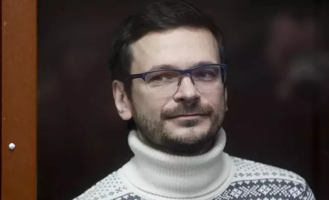 FILE - Russian opposition activist and former municipal deputy of the Krasnoselsky district Ilya Yashin stands inside a glass cubicle in a courtroom prior to a hearing in Moscow, Russia, Friday, Dec. 9, 2022. (Yury Kochetkov/Pool Photo via AP, File)