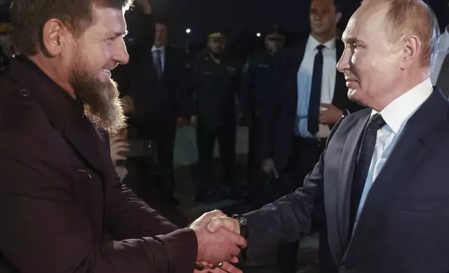 Russian President Vladimir Putin, right, is welcomed by Head of Russian Chechen Republic Ramzan Kadyrov upon his arrival at the city's airport in Grozny, Chechen Republic, Russia, Tuesday, Aug. 20, 2024. (Vyacheslav Prokofyev, Sputnik, Kremlin Pool Photo via AP)