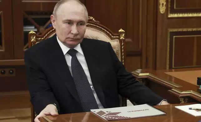 Russian President Vladimir Putin listens to the head of the Republic of Mordovia Artem Zdunov during their meeting at the Kremlin in Moscow, Russia, Thursday, Aug. 1, 2024. (Gavriil Grigorov, Sputnik, Kremlin Pool Photo via AP)