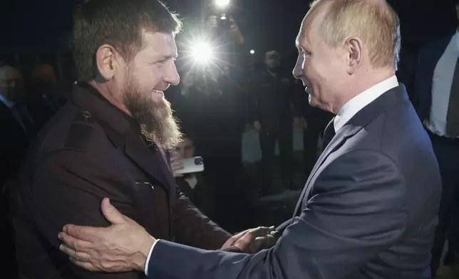 Russian President Vladimir Putin, right, is welcomed by Head of Russian Chechen Republic Ramzan Kadyrov upon his arrival at the city's airport in Grozny, Chechen Republic, Russia, Tuesday, Aug. 20, 2024. (Vyacheslav Prokofyev, Sputnik, Kremlin Pool Photo via AP)