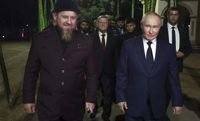 Russian President Vladimir Putin, right, and the head of Russian Chechen Republic Ramzan Kadyrov visit the grave of the first president of Chechnya Akhmat-Khadzhi Kadyrov in the village of Akhmat-Yurt, Chechen Republic, Russia, Tuesday, Aug. 20, 2024. (Vyacheslav Prokofyev, Sputnik, Kremlin Pool Photo via AP)