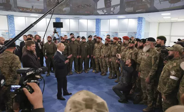 Russian President Vladimir Putin, accompanied by Head of the Chechen Republic Ramzan Kadyrov talks to Russian servicemen during his visit to the Russian Special Forces University in Gudermes, Chechen Republic, Russia, Tuesday, Aug. 20, 2024. (Alexei Danichev, Sputnik, Kremlin Pool Photo via AP)