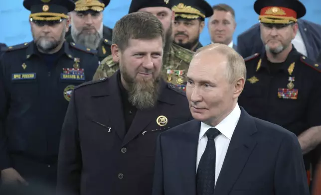 Russian President Vladimir Putin, second from right, accompanied by Head of the Chechen Republic Ramzan Kadyrov talks to servicemen during his visit to the Special Forces University in Gudermes, Chechen Republic, Russia, Tuesday, Aug. 20, 2024. (Alexei Danichev, Sputnik, Kremlin Pool Photo via AP)