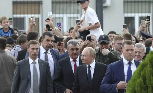 Russian President Vladimir Putin, accompanied by Head of the Republic of North Ossetia-Alania Sergei Menyailo walks in Vladikavkaz, Republic of North Ossetia-Alania, Russia, Tuesday, Aug. 20, 2024. (Gavriil Grigorov, Sputnik, Kremlin Pool Photo via AP)