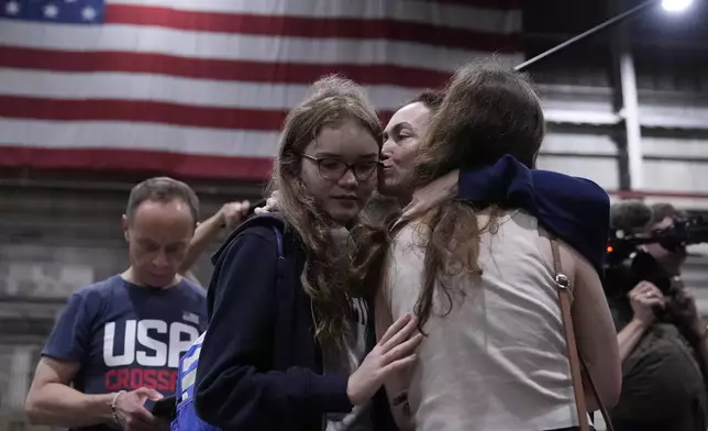 Alsu Kurmasheva, second from right, hugs family members after she arrived at Kelly Field after she was released by Russia, Friday, Aug. 2, 2024, in San Antonio. (AP Photo/Eric Gay)