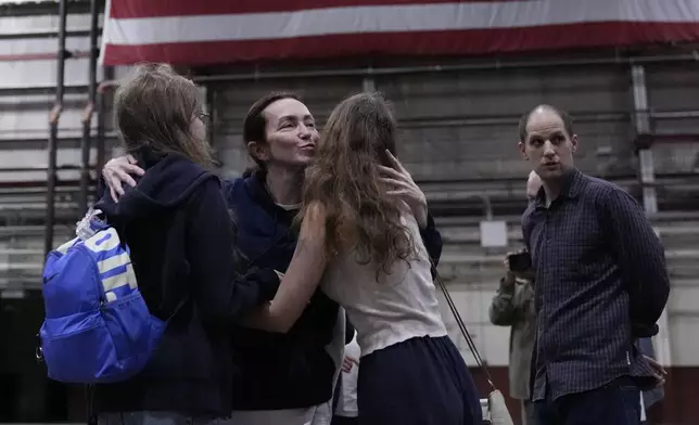 Alsu Kurmasheva, second from left, is greeted by family members after she arrived at Kelly Field after she was released by Russia, Friday, Aug. 2, 2024, in San Antonio. Reporter Evan Gershkovich, also released, is at right. (AP Photo/Eric Gay)